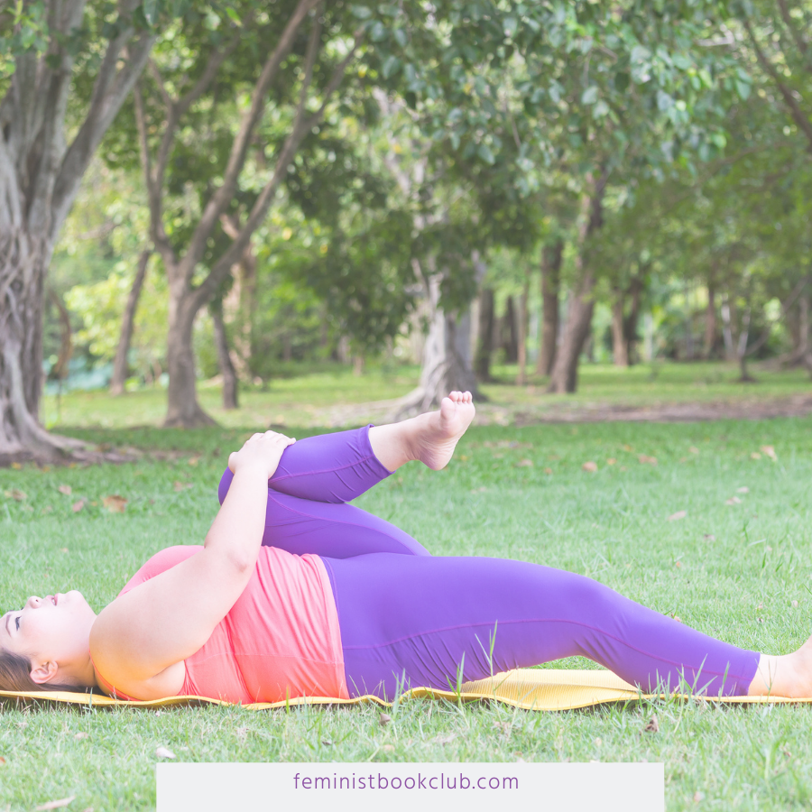 Why Body Positivity Feels a Bridge Too Far - larger woman doing reclined stretches on a yoga mat