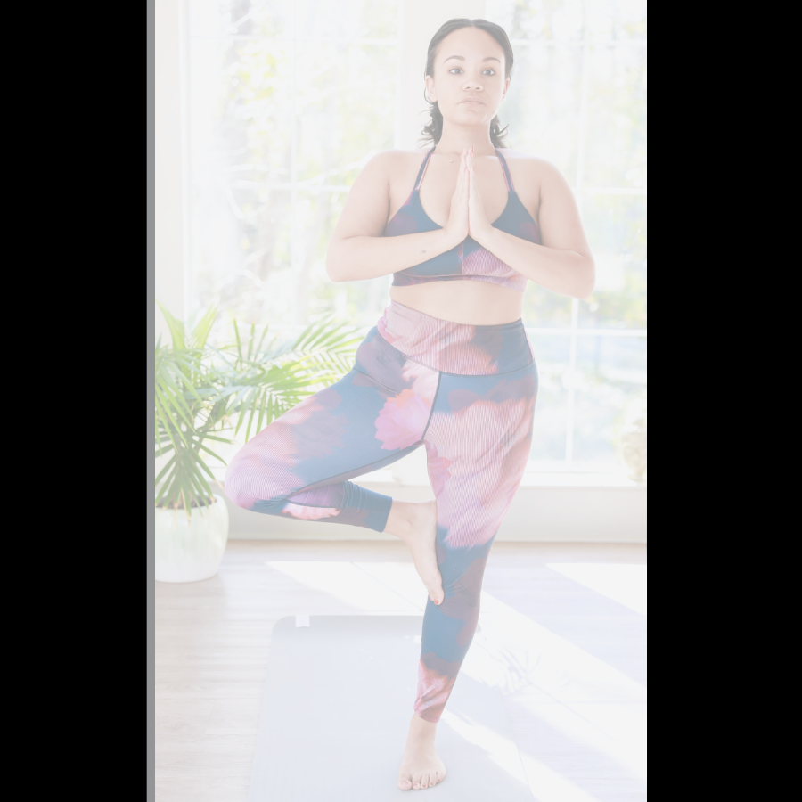 woman of color balancing in tree pose