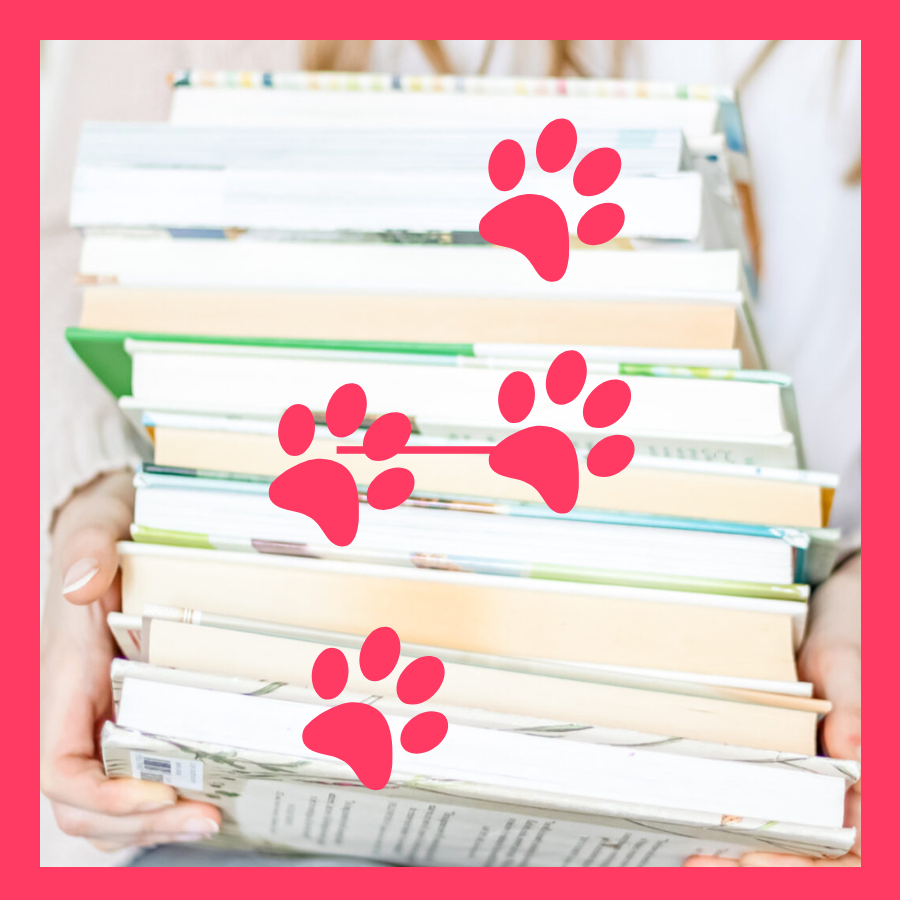 stack of books with pink animal paw prints