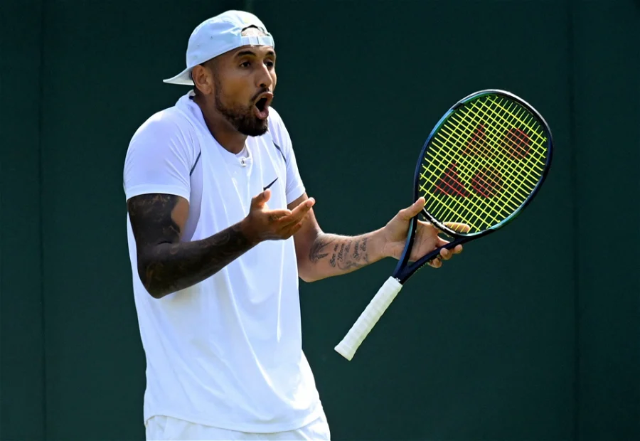 Nick Kyrgios holding a tennis racquet, yelling at someone.