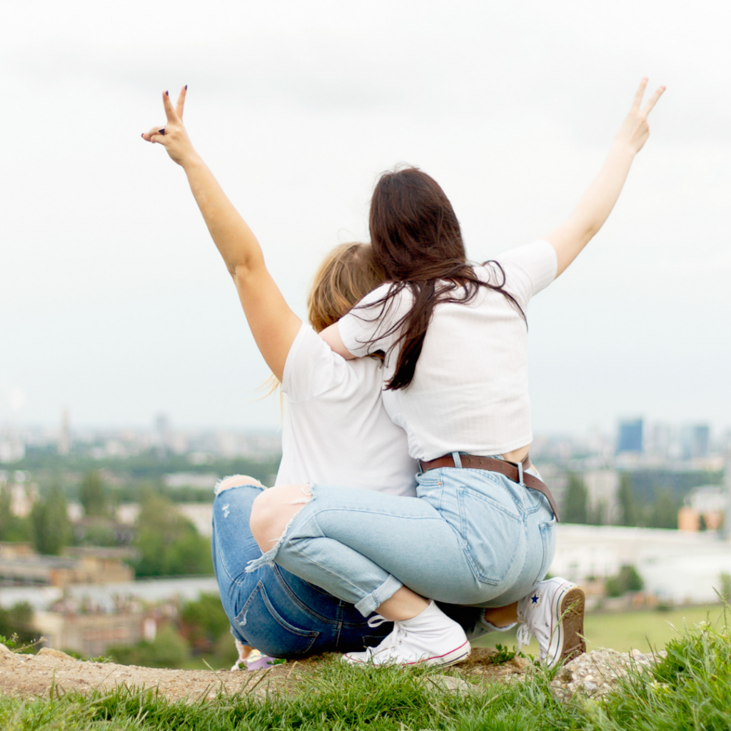 Two femmes throw peace signs to the air as they sing Taylor Swift's newest versions of her songs. Then they go check out a WNBA game and read feminist romance novels at the end of the day.