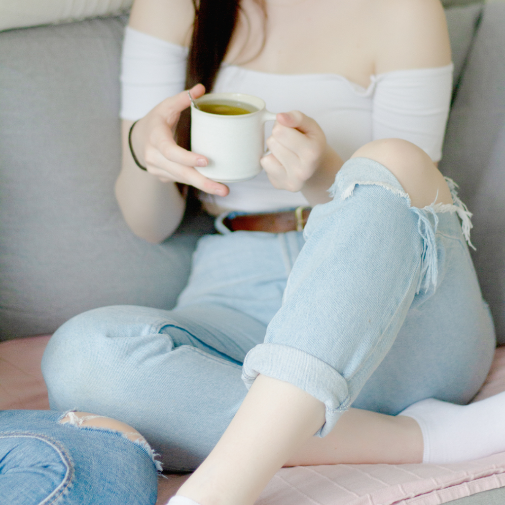 Femme presenting person sips coffee while she thinks about books that should be movies and reading The Rachel Incident by Caroline O'Donoghue