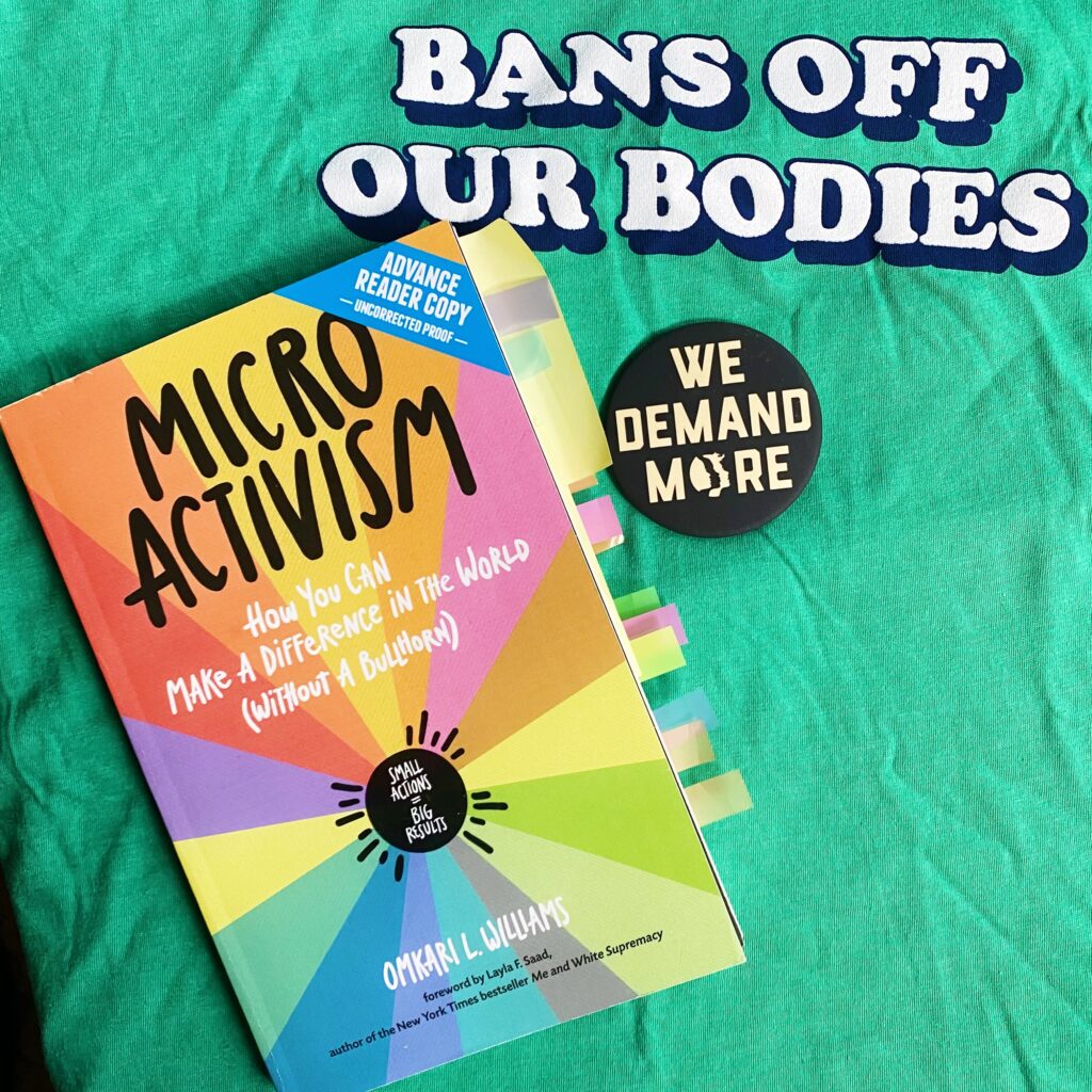 The book Micro Activism on top of a green shirt that says "Bans Off Our Bodies"